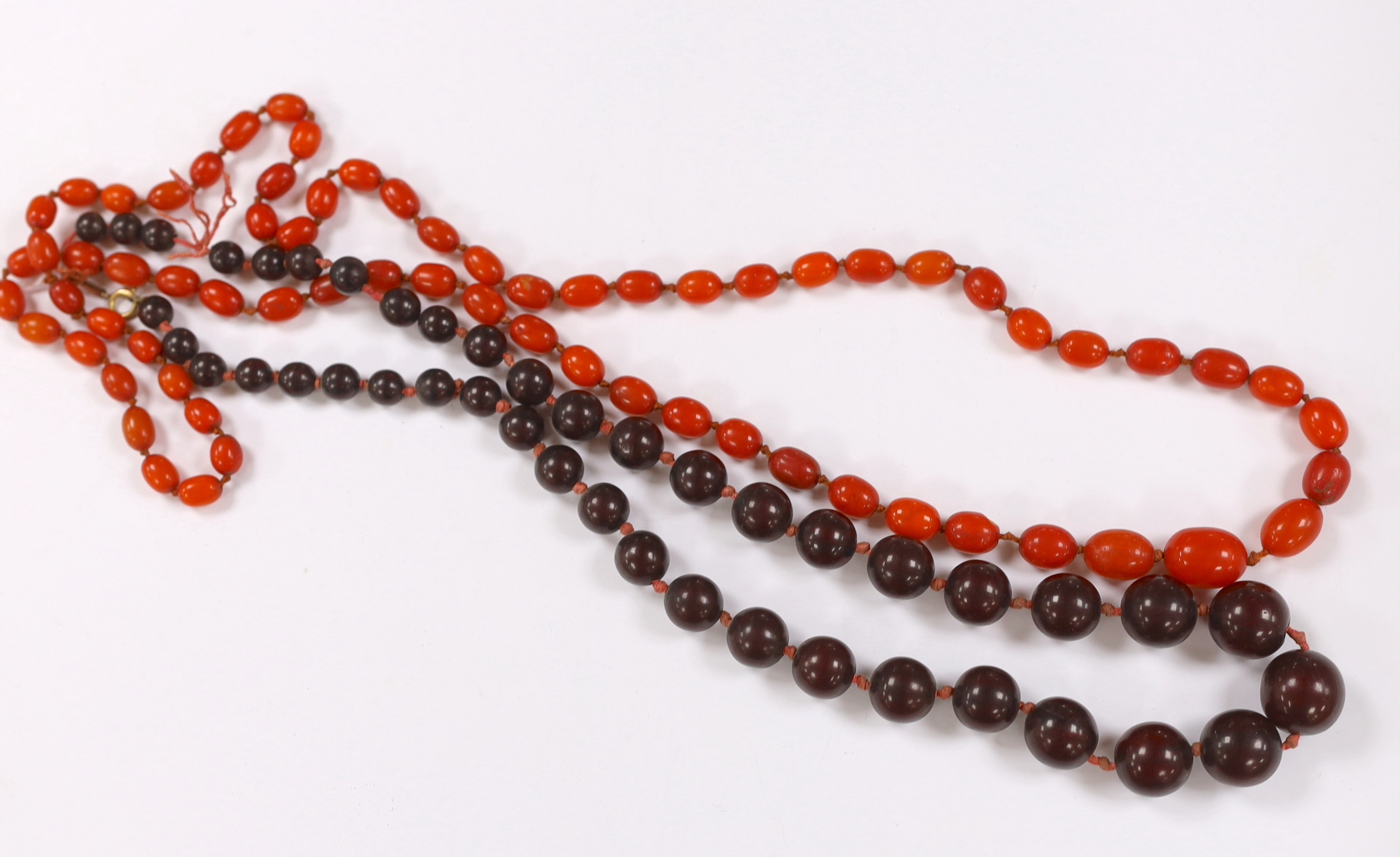 A single strand simulated cherry amber bead necklace, 70cm, gross weight 80 grams and one other necklace.